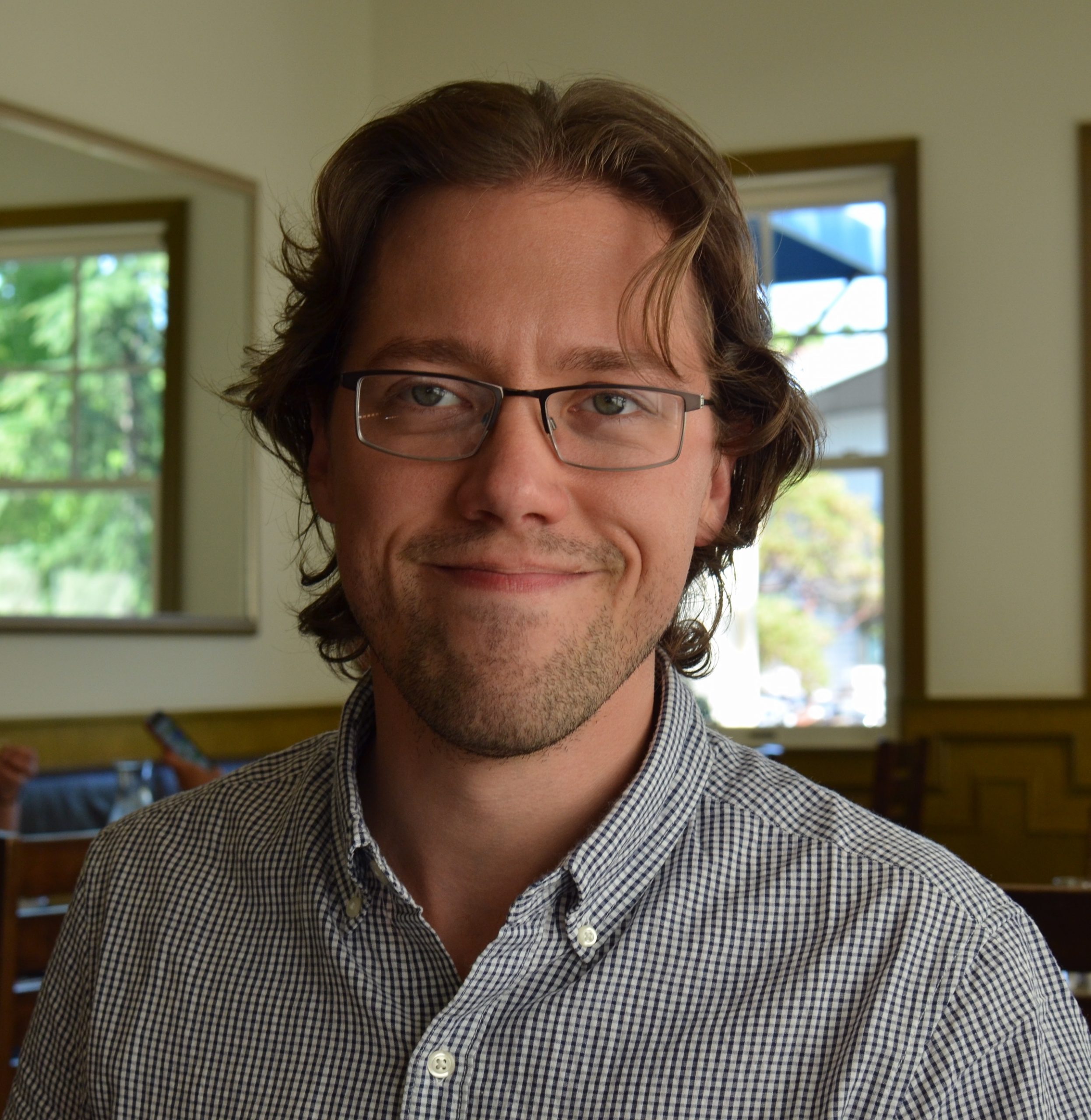 A profile photo of Joseph C. Osborn, a man with brown hair and glasses.